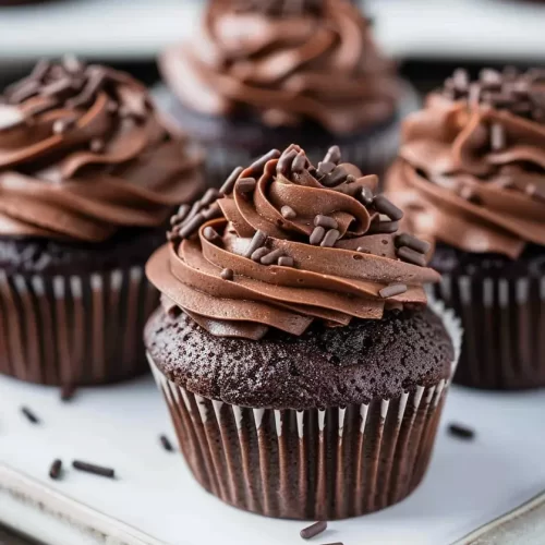 Super Moist Chocolate Cupcakes with rich cocoa crumb and glossy chocolate buttercream swirl.