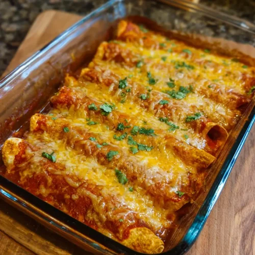 Delicious Cottage Cheese Chicken Enchiladas topped with red sauce and cheese