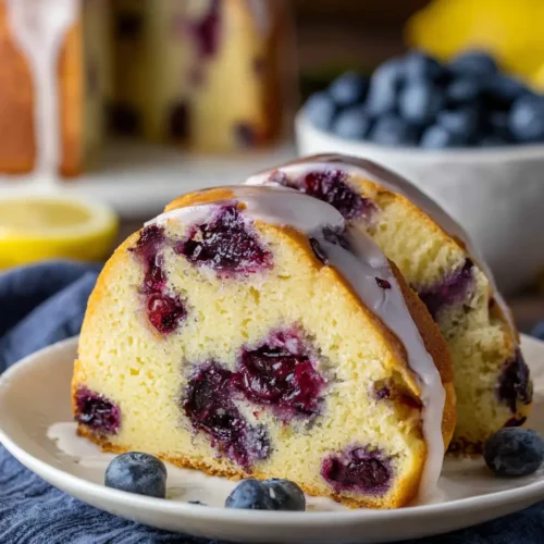 Moist Lemon Blueberry Pound Cake topped with lemon glaze and fresh blueberries