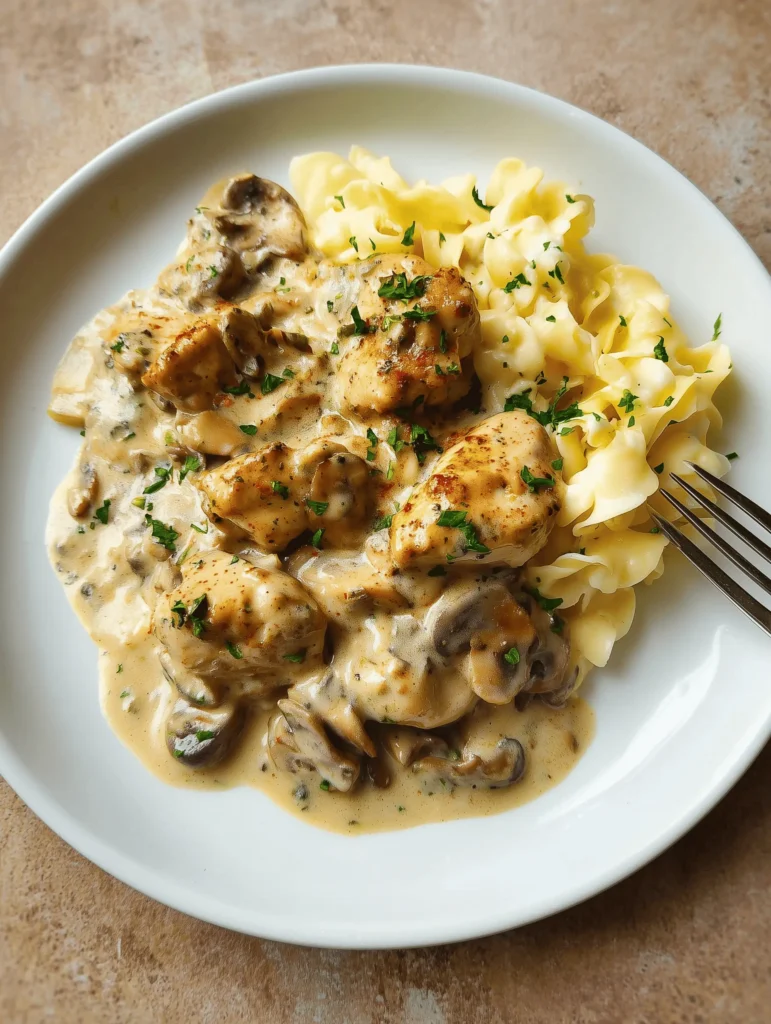 Delicious Creamy Chicken and Mushroom Stroganoff served over egg noodles.