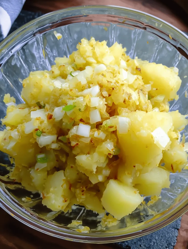 Creamy Southern Potato Salad with eggs, mayo, mustard, and pickles served in a bowl.