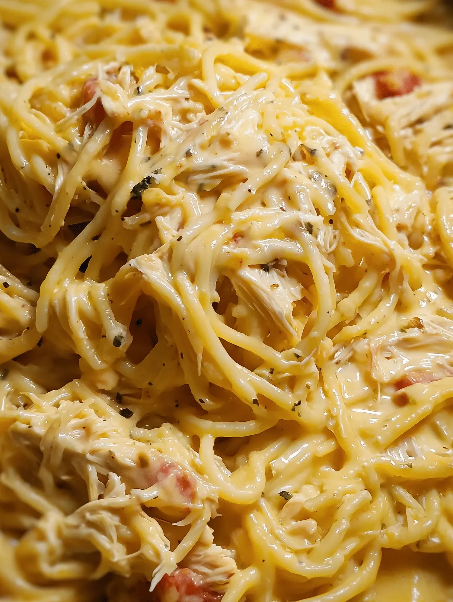 Delicious Crockpot Chicken Spaghetti with cheese and tomatoes in a slow cooker.