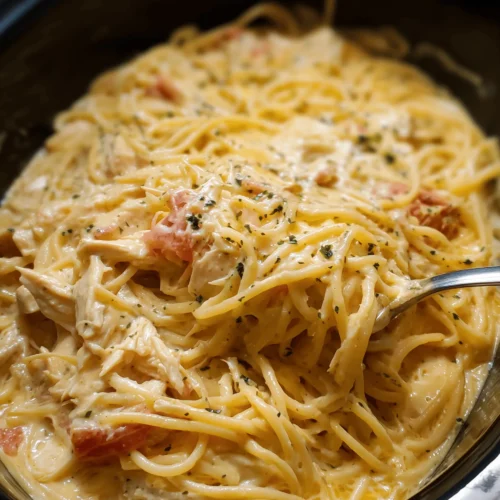 Delicious Crockpot Chicken Spaghetti with cheese and tomatoes in a slow cooker.