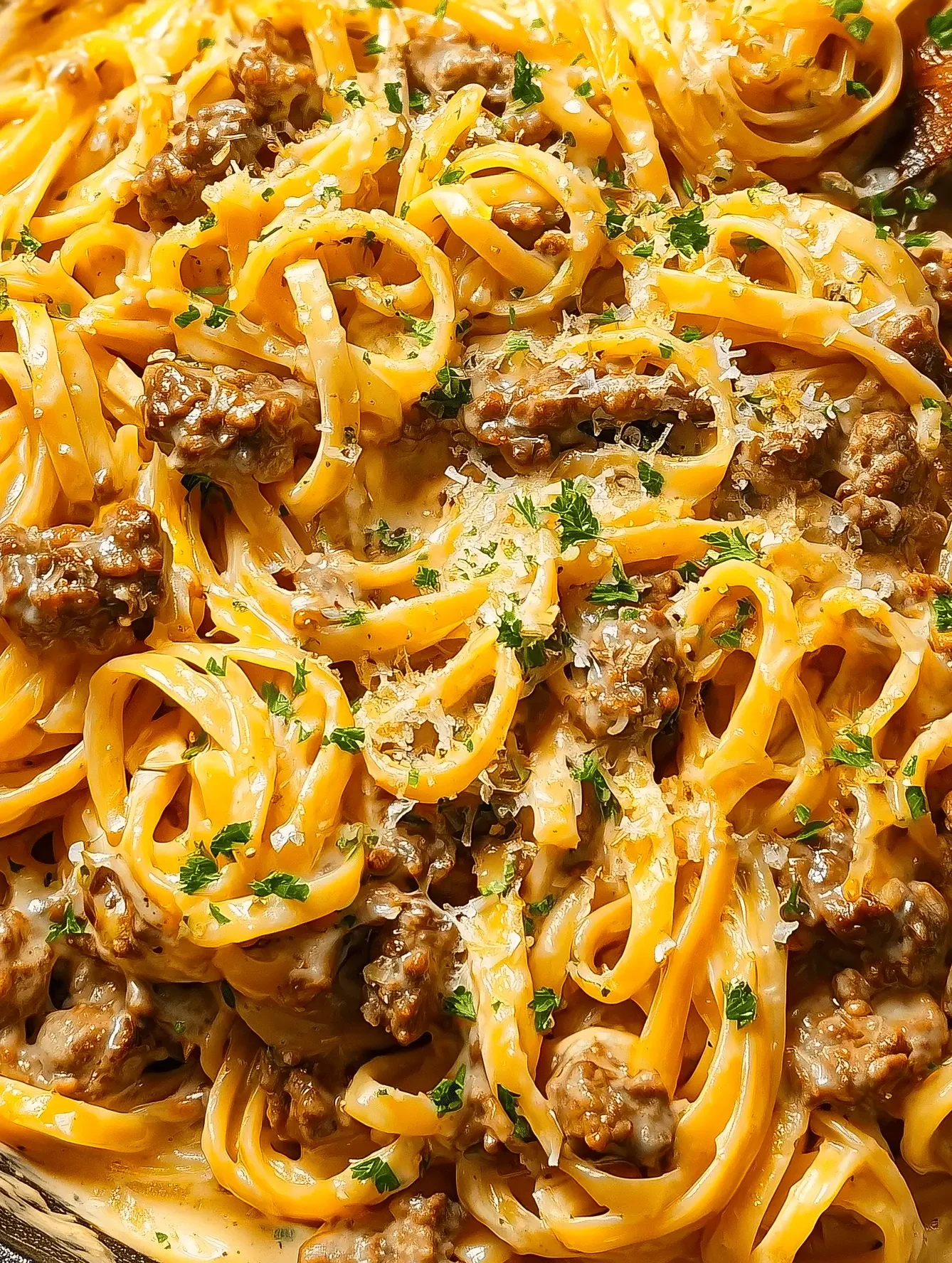 One Pot Creamy Beef and Garlic Butter Pasta served in a bowl with herbs on top