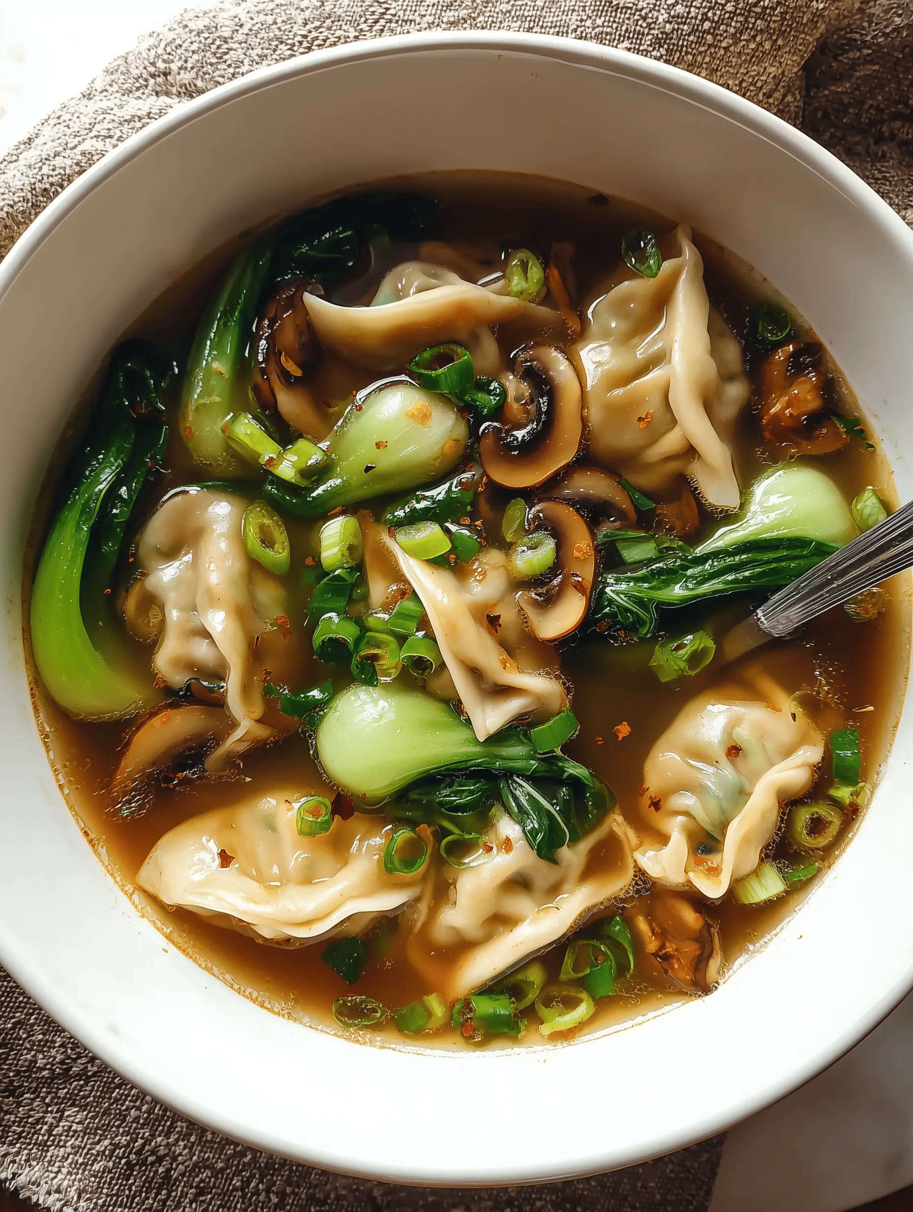 Delicious Potsticker Soup with mushrooms and bok choy served in a bowl