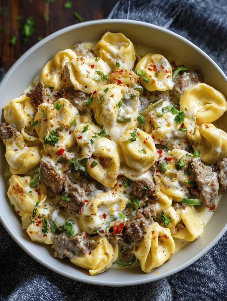 Make this creamy Philly Cheesesteak Tortellini Pasta for an easy weeknight dinner packed with beef, peppers, onions, cheese tortellini, and rich cheesy sauce.