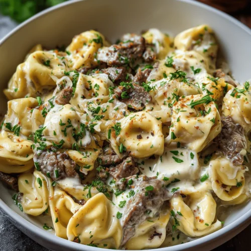 Make this creamy Philly Cheesesteak Tortellini Pasta for an easy weeknight dinner packed with beef, peppers, onions, cheese tortellini, and rich cheesy sauce.